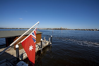 New Zealand Flag on Ferry Dock with City Skyline