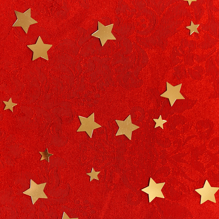 Red textured background with scattered gold star confetti