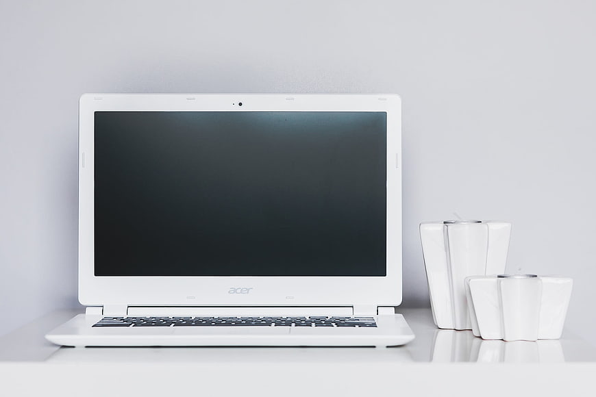 White Acer Laptop on Minimalist Desk with Vases