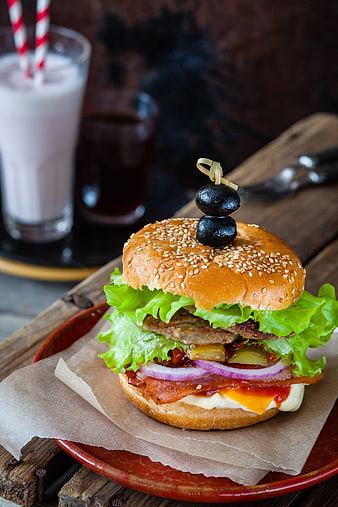 Delicious Gourmet Burger with Olives and Milkshake