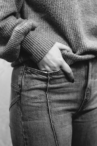 Black and white close-up of woman in sweater and jeans