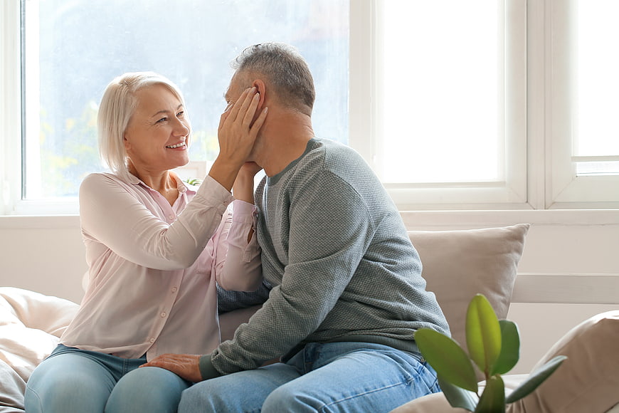 Happy Senior Couple Sharing Intimate Moment on Sofa