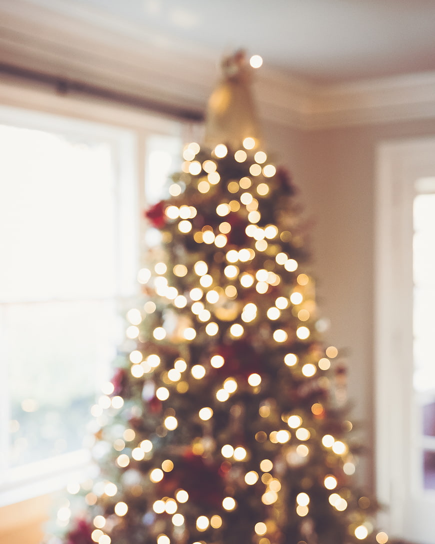 Blurred Christmas Tree with Bokeh Lights Background