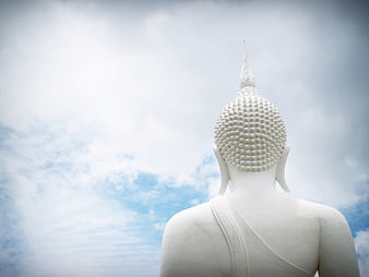 White Buddha Statue Back View Against Blue Sky