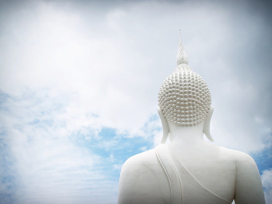 White Buddha Statue Back View Against Blue Sky