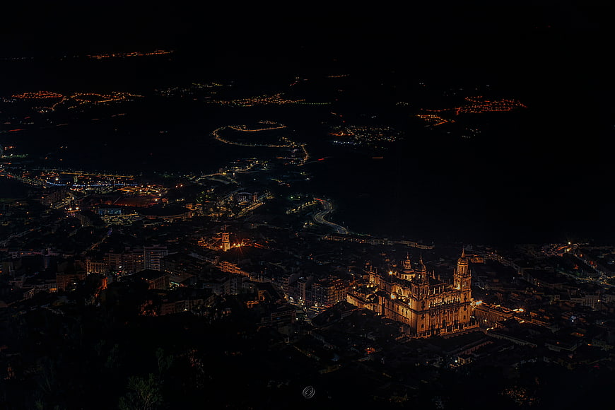 Aerial night view of Seville Cathedral and city lights