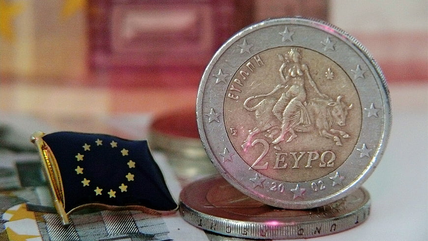 Greek 2 Euro Coin and EU Flag on Banknotes