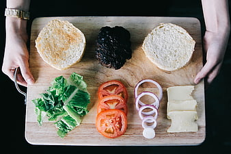 Top view of burger ingredients on wooden cutting board