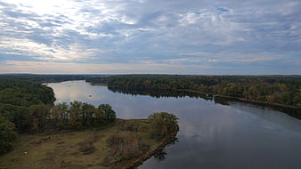 Aerial View of Serene River Winding Through Autumn Forest