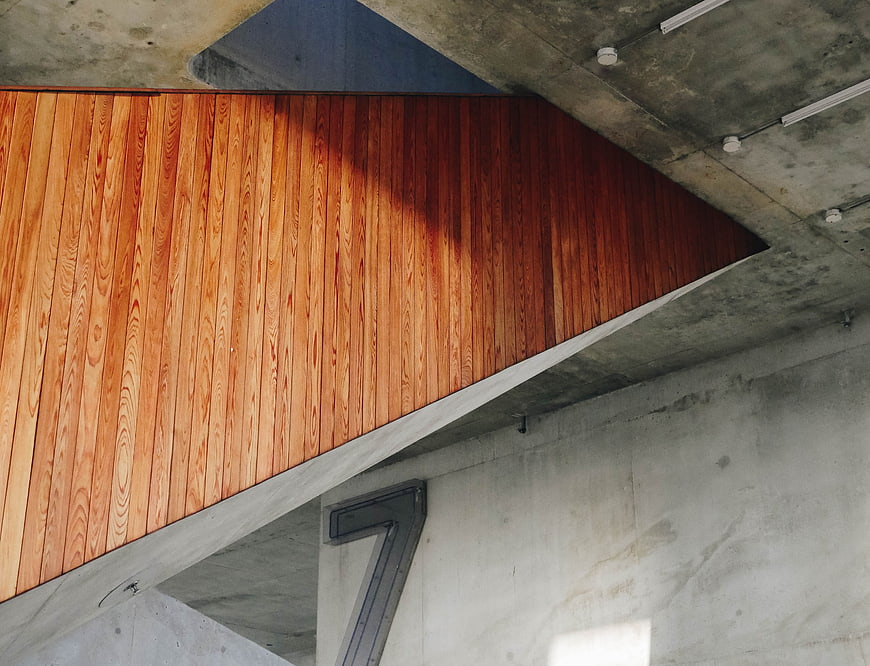 Modern concrete architecture with warm wooden paneling detail