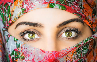 Close-up portrait of a woman wearing a colorful patterned headscarf