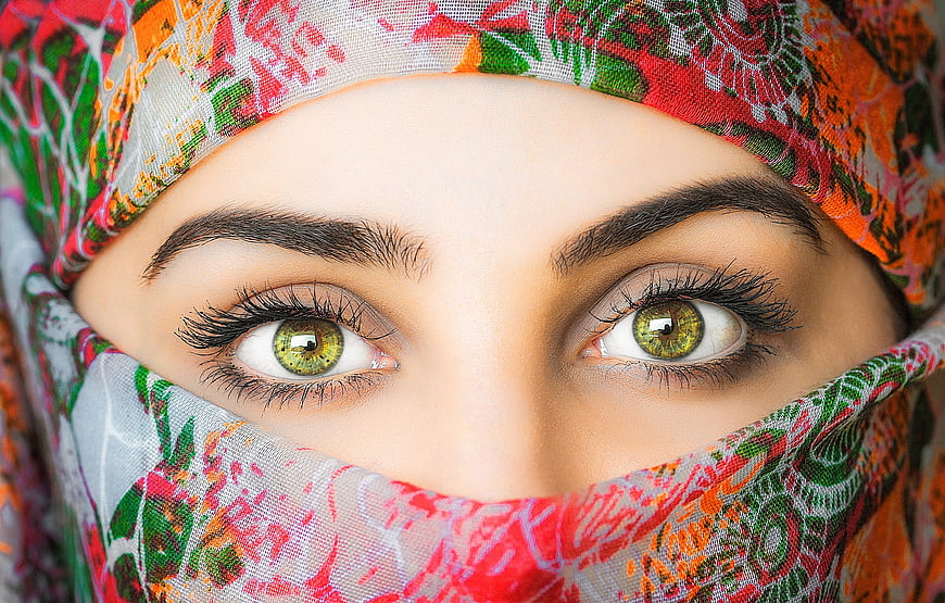 Close-up portrait of a woman wearing a colorful patterned headscarf