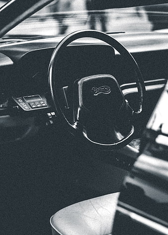 Vintage black and white car interior with steering wheel