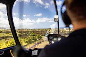 Pilot View from Helicopter Cockpit Over Coastal Landscape