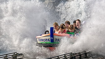Thrilling water ride splash with screaming riders