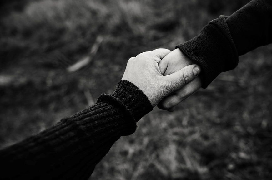 Black and White Close-Up of Couple Holding Hands