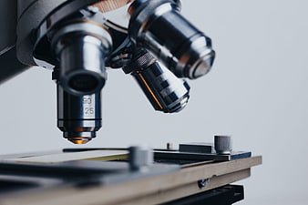 Close-up of microscope objective lenses and stage in laboratory
