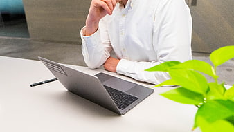 Business person working on laptop in modern office