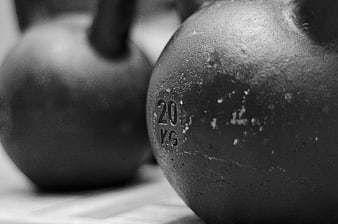 Close-up of black 20kg kettlebells in gym