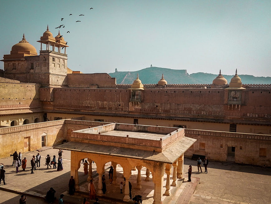 Amber Fort courtyard with sandstone architecture and visitors