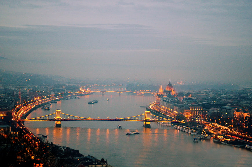 Panoramic View of Budapest Cityscape at Dusk with Illuminated Bridges