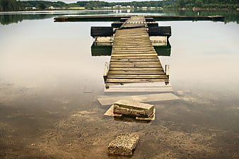 Wooden Dock Extending into Calm Lake Water
