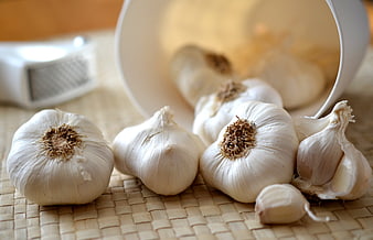 Fresh Garlic Bulbs and Cloves on Woven Mat