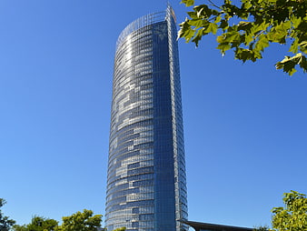 Modern Glass Skyscraper Against Blue Sky
