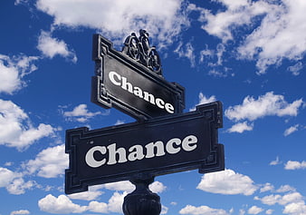 Black street signs reading Chance against blue sky