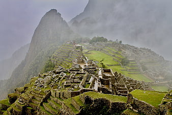 Machu Picchu ruins shrouded in mist and fog