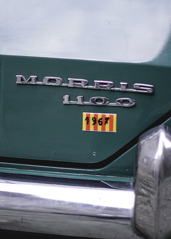 Close-up of vintage Morris 1100 car badge with 1967 sticker