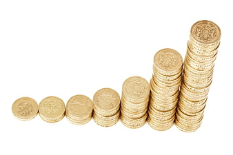 Stacks of gold coins showing financial growth on white background