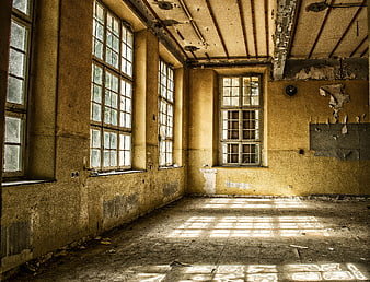 Abandoned Room Interior With Sunlight Patterns And Peeling Walls