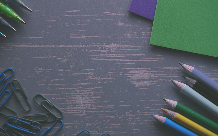 Flat lay of colorful stationery on gray wooden background