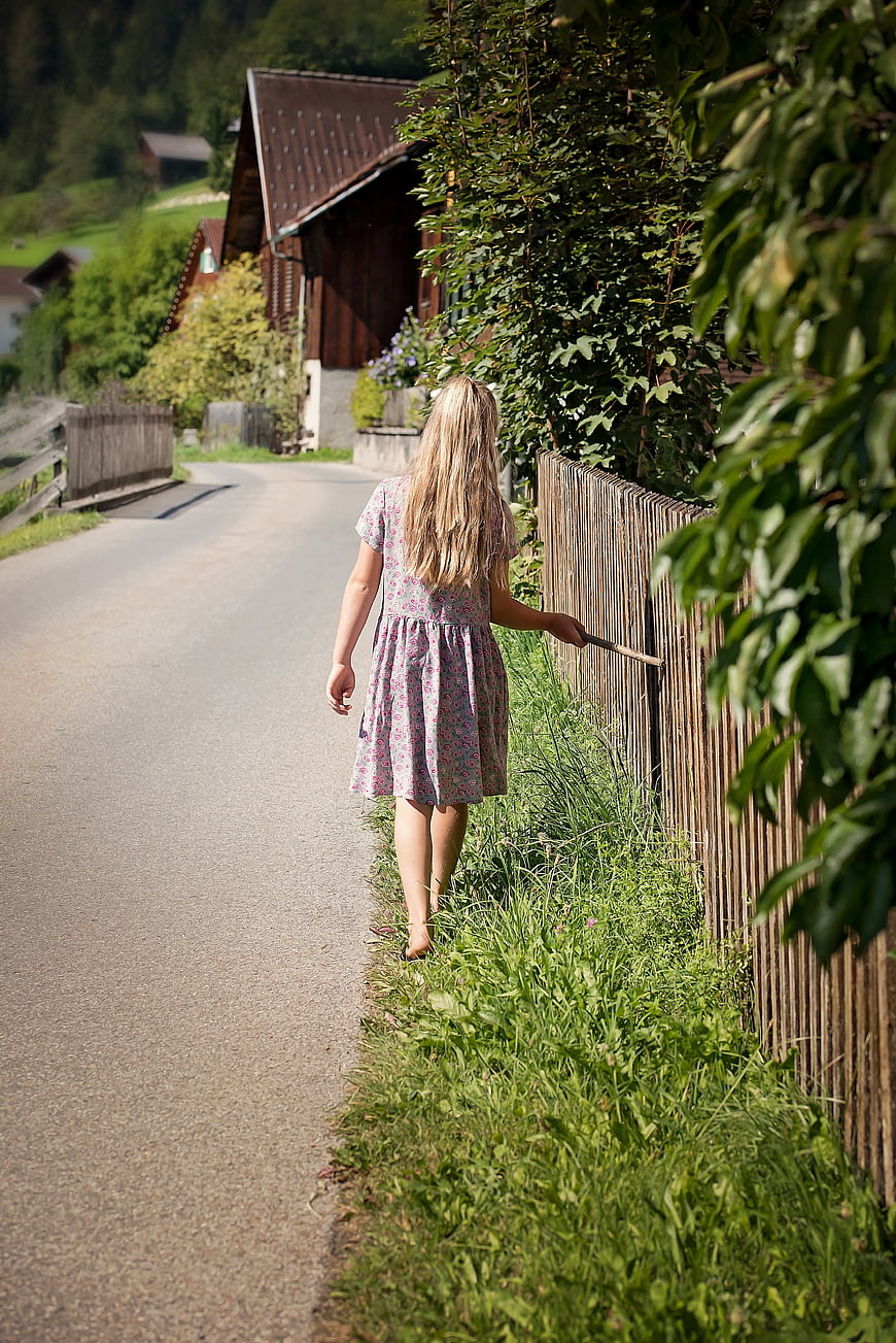 Young Girl Walking Along Countryside Road