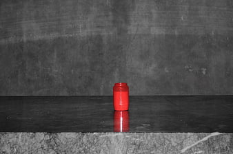 Red Candle on Dark Concrete Surface