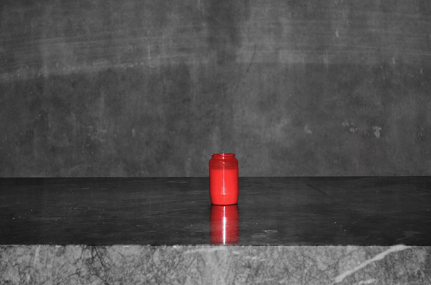 Red Candle on Dark Concrete Surface