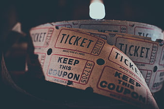 Vintage paper ticket roll close-up with keep this coupon text