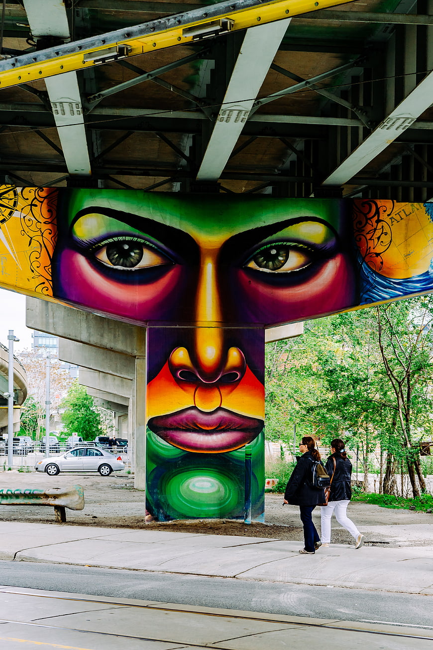 Vibrant Street Art Mural Under Urban Bridge