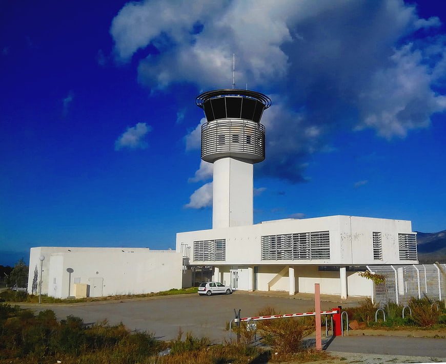 Modern white airport control tower against blue sky