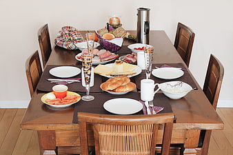 Rustic wooden dining table set for a hearty breakfast