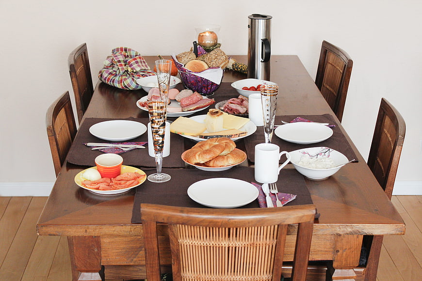 Rustic wooden dining table set for a hearty breakfast
