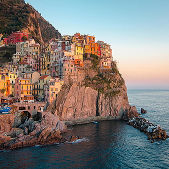 Colorful houses on cliffs in Cinque Terre, Italy at sunset