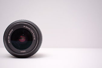 Black Nikon Camera Lens on White Background