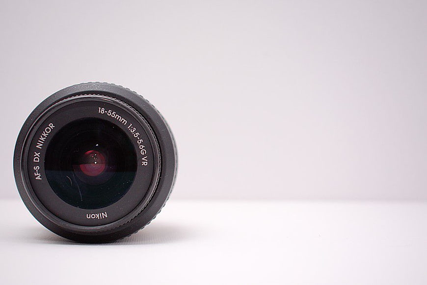 Black Nikon Camera Lens on White Background