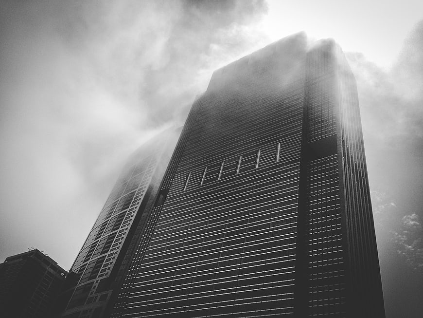 Black and white skyscraper emerging from thick fog