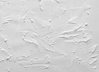 White textured plaster wall background with abstract paint strokes