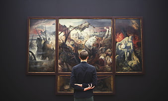 Man viewing war triptych painting in museum gallery