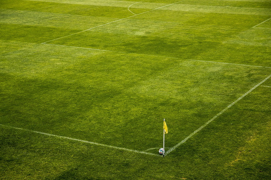Aerial View of Soccer Ball and Corner Flag on Green Pitch