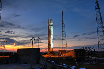 SpaceX Falcon 9 rocket on launch pad at sunset